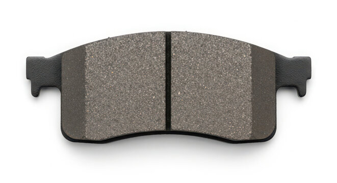 Single automotive brake pad isolated on white background showcasing textured friction material surface for safe vehicle stopping performance and maintenance