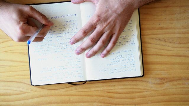  Top view shot of hands writing in notebook