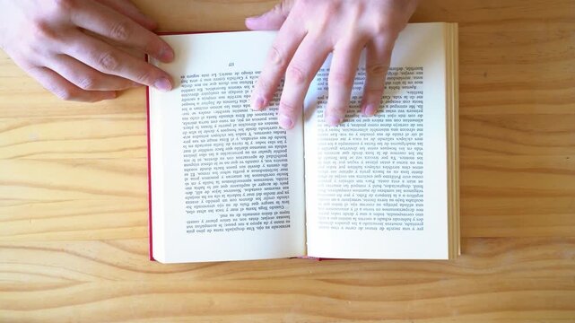 Top view shot of hands reading book