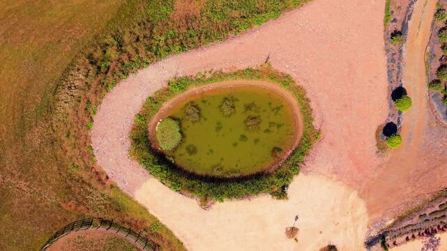 Aerial Top Down View of Small Pond Encircled by Paths in Starry Night Resort Near Visoko Bosnia