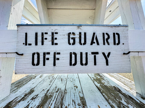 Life guard off duty sign on beach lifeguard stand