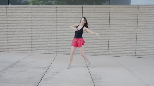 Energetic dance instructor performing outdoor choreography