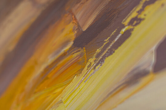 Abstract macro composition of yellow, brown and gray oil paint with expressive brush strokes and selective focus. Artistic textured background for modern creative projects.