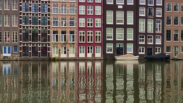 Famous dancing houses historic gabled facades at Damrak in Amsterdam