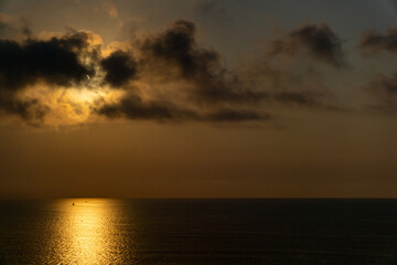 Partial solar eclipse over ocean horizon at sunset © Leire Iragi