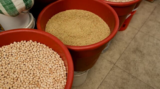 Dried Chickpeas And Amaranth Grains In Red Plastic Bins At Mexican Market