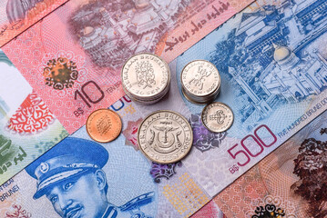 Brunei paper money, dollar banknotes and sen coins as currency for exchange or travel. Brunei money © chernikovatv