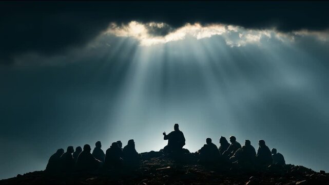 Jesus shares thoughts with a group of followers on a mountain at dusk. Light shines through clouds, creating a dramatic setting for this gathering.