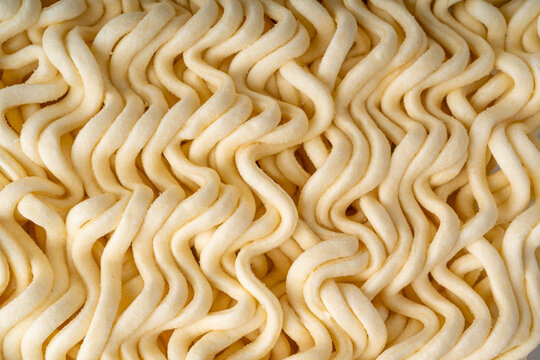 Instant noodles texture background, dry ramen noodle macro pattern