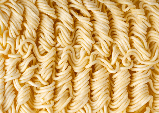 Instant noodles texture background, dry ramen noodle macro pattern