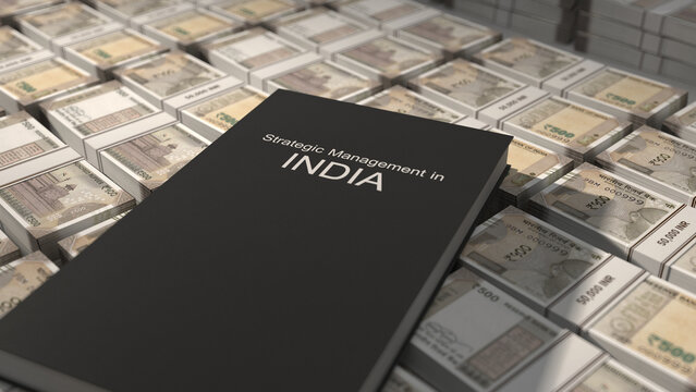 Strategic management in India book on top of Indian rupee bill bundles