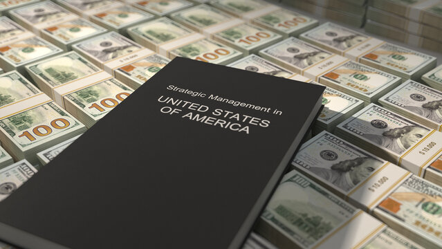 Strategic management in United States of America book on top of US dollar bill bundles