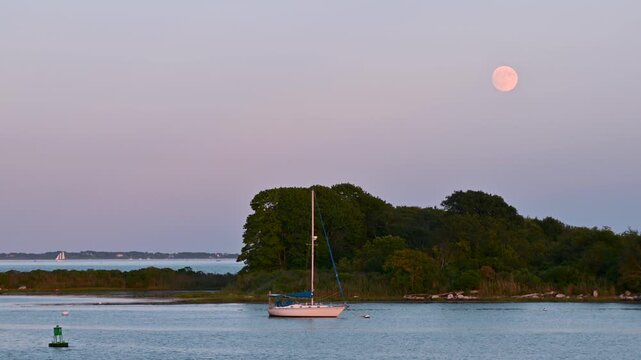 Groton, Connecticut, USA &ndash; Sturgeon Moon Over Sailboat and Coastal Channel at Blue Hour