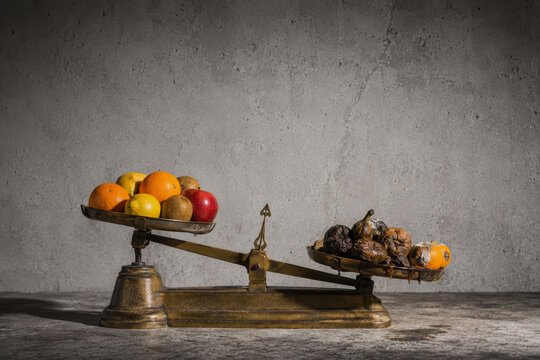 Fresh and Rotten Fruit on Balance Scale &ndash; Quality and Food Loss