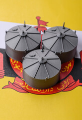 Liquefied gas storage tanks set against the Brunei flag, representing the concept of supply © chernikovatv