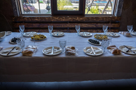 Elegant Dining Table Set with Traditional Appetizers and Olives in Restaurant.