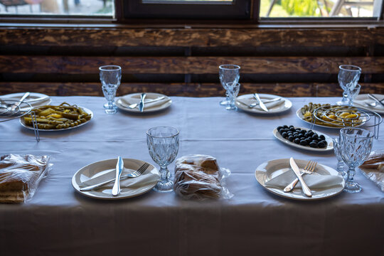 Elegant Dining Table Set with Traditional Appetizers and Olives in Restaurant.