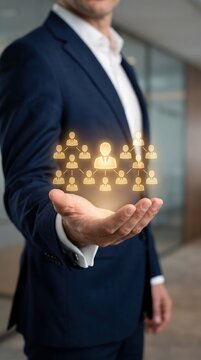 businessman presenting glowing organizational chart icons in open hand, concept of company hierarchy, team structure and human resources