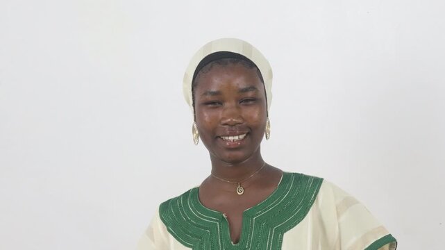 Smiling young African woman in traditional embroidered dress