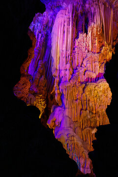 Guilin, China, Reed Flute Cave interior showcasing dramatic stalactites and stalagmites, rich textures, and multicolored lighting