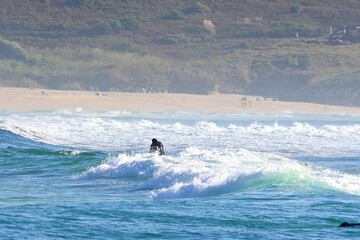 Surfers amidst powerful waves and water mist at Doniños Beach, Ferrol , Spain , May 18 , 2026 © GenadiyGM