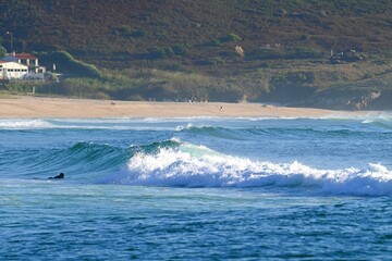 Surfers amidst powerful waves and water mist at Doniños Beach, Ferrol , Spain , May 18 , 2026 © GenadiyGM
