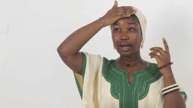 A worried young African woman, hand on her forehead, expressing stress