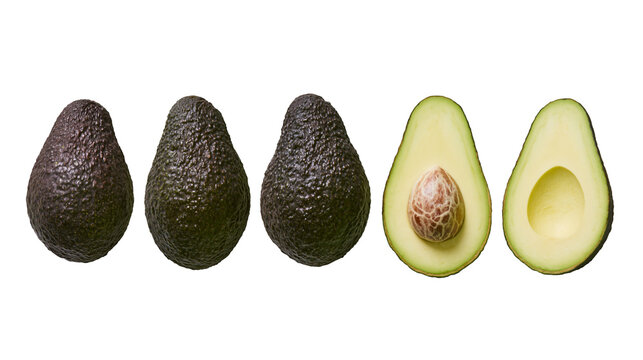 Isolated group of ripe Hass avocados, whole and cut in half showing seed and empty pit