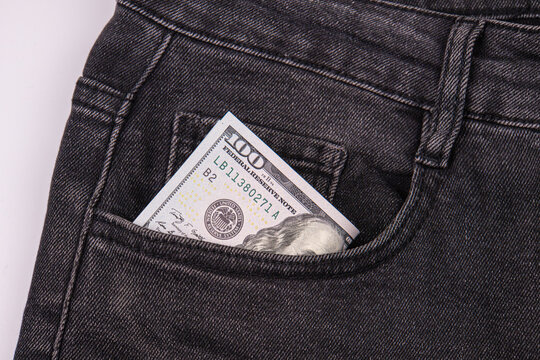 100 bill in jeans pocket, crisp paper contrasts with dark denim texture, simple commercial style, practical everyday setting