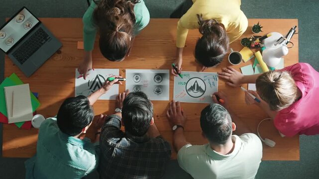 Time lapse of business team write graphic logo on meeting table with colorful sticky notes and design while explain idea. Project manager sharing idea and explain concept art to smart team. Symposium.