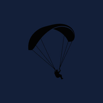 A Solitary Paraglider Soars Against A Deep Blue Sky