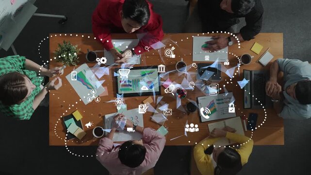 A diverse group of professionals collaborates on a dynamic business project, utilizing modern technology and visual data elements in a contemporary office setting. Raster