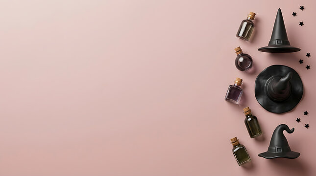 Halloween witch hats and magic potion bottles on a soft pink background with copy space