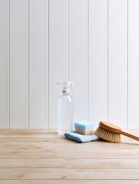 Cleaning spray bottle, microfiber cloth, sponge, and brush for hygiene tasks