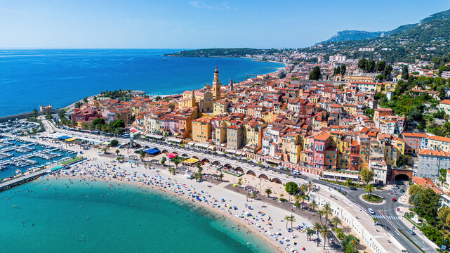 Aerial drone view of the old town of Menton overlooking the Sablettes Beach on the coast of the Mediterranean Sea in the French Riviera
