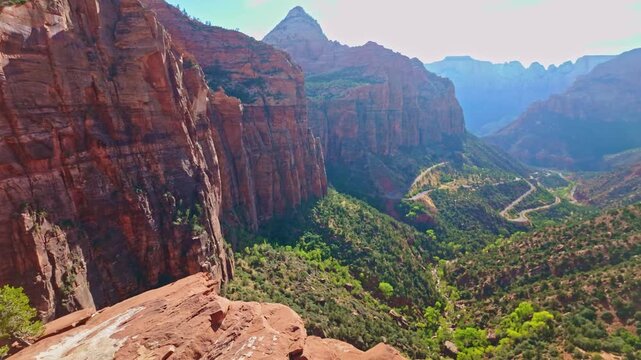 Golden sunset light glows over Zion National Park from the top of Pine Creek Canyon Overlook Trail