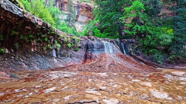 Stunning Archangel Falls cascades at the entrance to the iconic Subway tunnel in Zion National Park