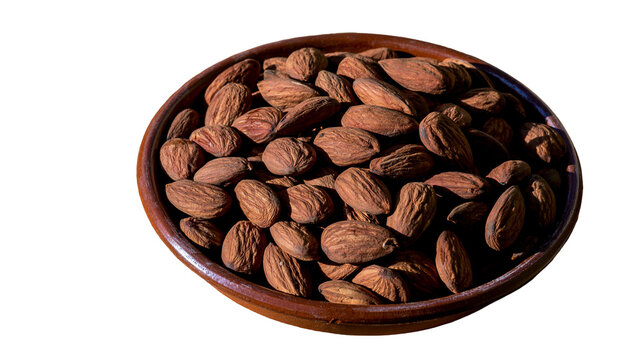 Isolated bowl of fresh whole organic almonds, healthy snack food ingredient for cooking.