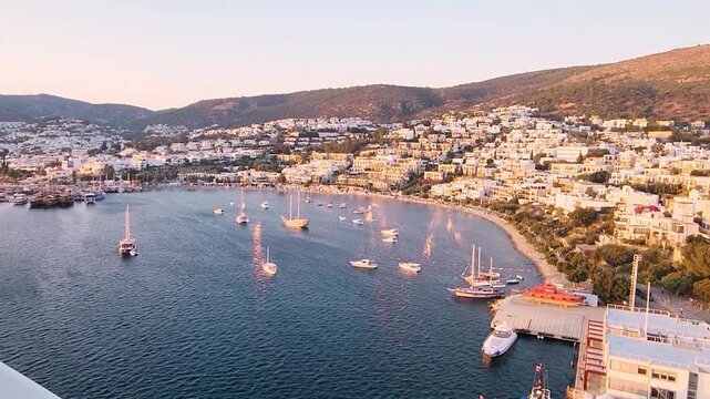 Evening view of Bodrum Harbor with yachts and calm sea from cruise liner deck in Turkey. Handheld