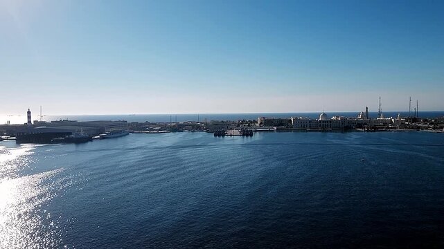 Forward view from bow of passenger cruise liner departing harbor on sunny day. Handheld