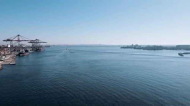 Forward view from bow of passenger cruise liner departing harbor on sunny day. Handheld