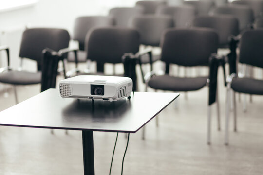 White Projector Sits On Table In Empty Conference Room