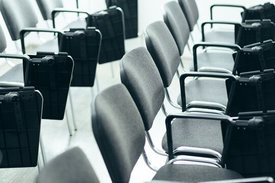 Rows Of Empty Conference Chairs With Chrome Frames In A Modern Office