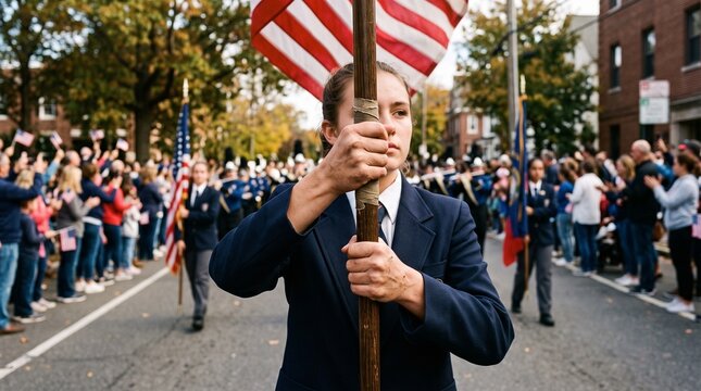 Young woman carries American flag in a patriotic parade with spectators