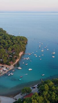 FKK Naturist Baldarin Campsite In Punta Kriza On Cres Island, Croatia, Filmed By Drone During A Beautiful Summer Evening. Aerial Views Show Campervans, Motorhomes, Coastal Nature at Sunset