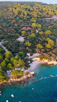 FKK Naturist Baldarin Campsite In Punta Kriza On Cres Island, Croatia, Filmed By Drone During A Beautiful Summer Evening. Aerial Views Show Campervans, Motorhomes, Coastal Nature at Sunset
