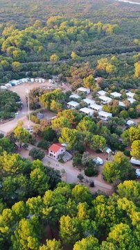 FKK Naturist Baldarin Campsite In Punta Kriza On Cres Island, Croatia, Filmed By Drone During A Beautiful Summer Evening. Aerial Views Show Campervans, Motorhomes, Coastal Nature at Sunset