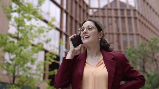 Young businesswoman engaging in a phone conversation downtown