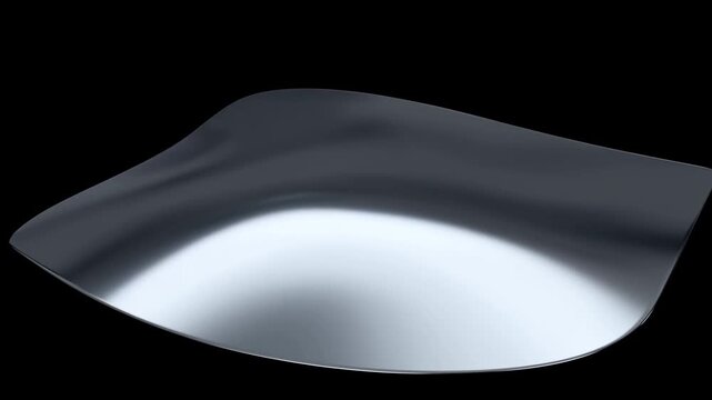 Reflective silver metal sheet with curved surface against a black background