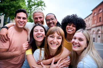 Mobile selfie of group young multi-ethnic beautiful friends having fun together outdoors. Excited...